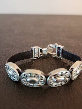 Brighton Harmony Bandit Bracelet silver plated conchos with a buckle closure.